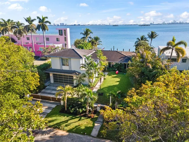 an aerial view of a house with swimming pool patio and outdoor seating