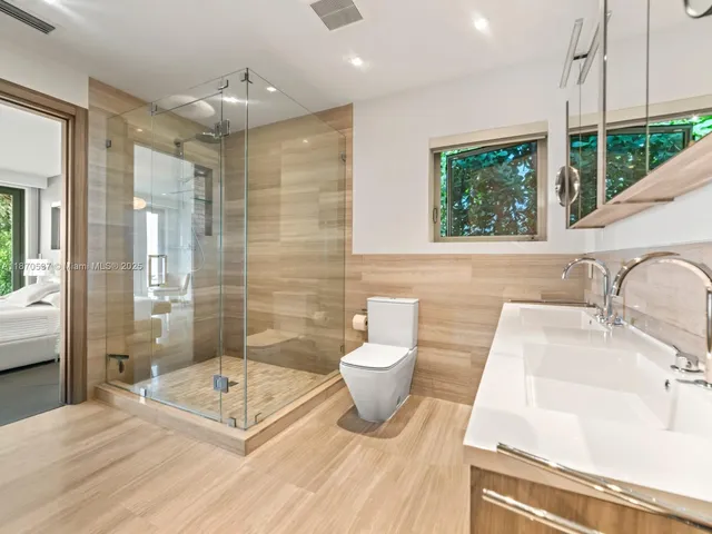 a bedroom with a large bed and a large window