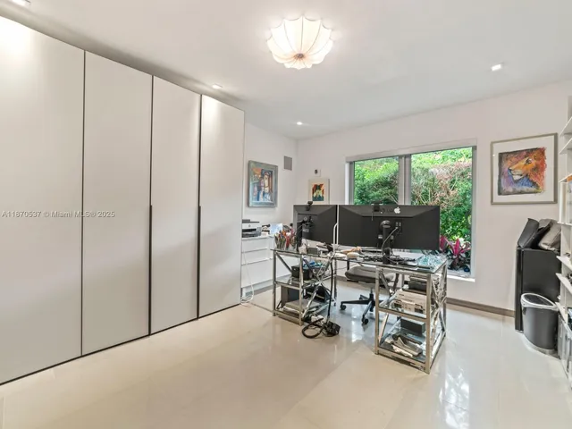 a view of a room with gym equipment and a flat screen tv