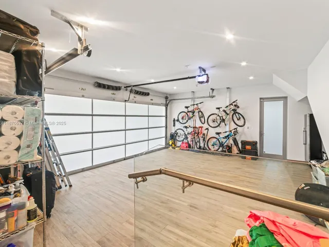 a front view of a house with a yard and a lot of flower plants