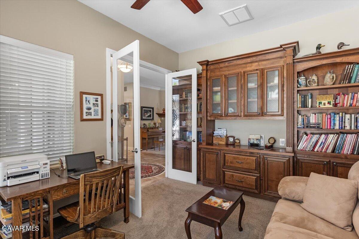 23840 Martingale Way Tehachapi, CA 93561 - Photo 7 of 63 a living room with furniture a bookshelf and a window
