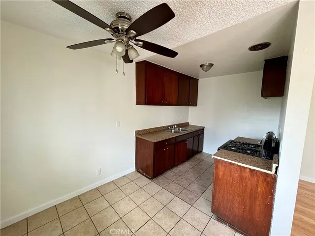 a kitchen with stainless steel appliances a stove a sink and a refrigerator