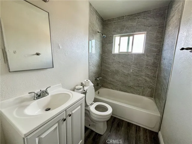 a bathroom with a sink mirror toilet and bathtub