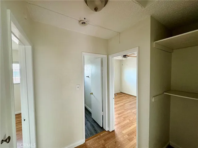 a view of hallway with wooden floor