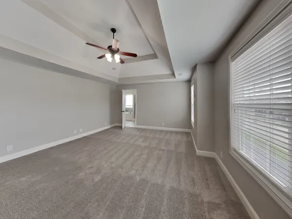 a view of a livingroom with a ceiling fan window and hardwood floor