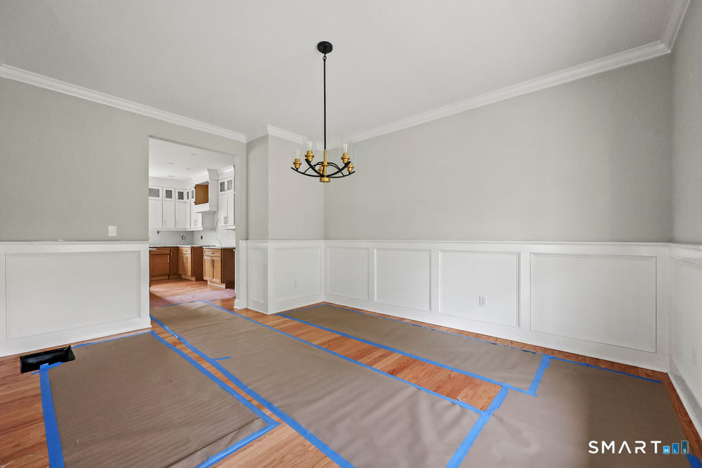 8 Ridgewood Club Road Prospect, CT 06712 - Photo 12 of 40 a bedroom with a bed and a chandelier
