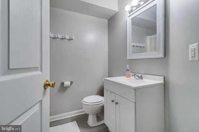 a bathroom with a toilet a sink and mirror