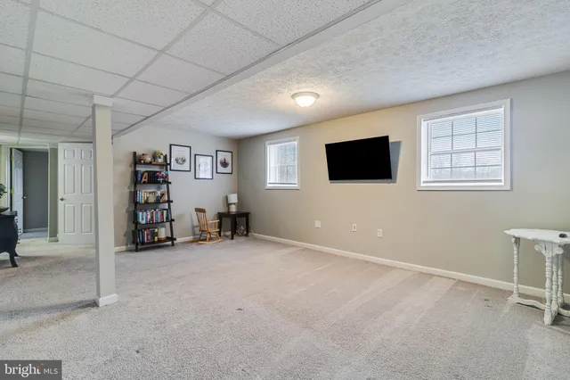 a view of a livingroom with furniture and a window