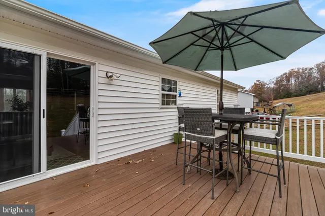a table and chairs in patio of the house