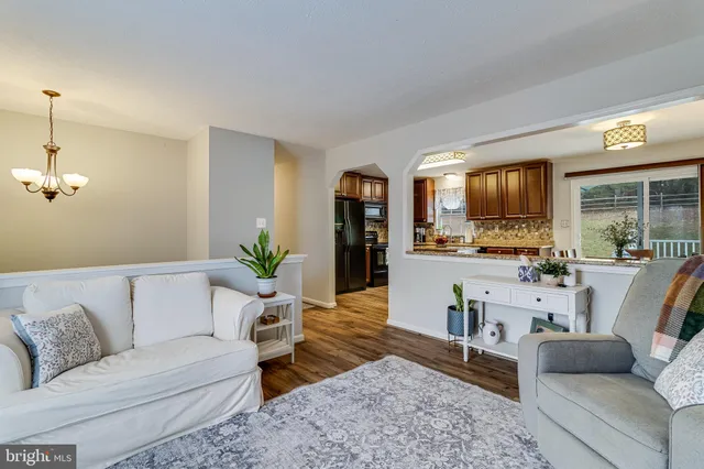 a living room with furniture and kitchen view