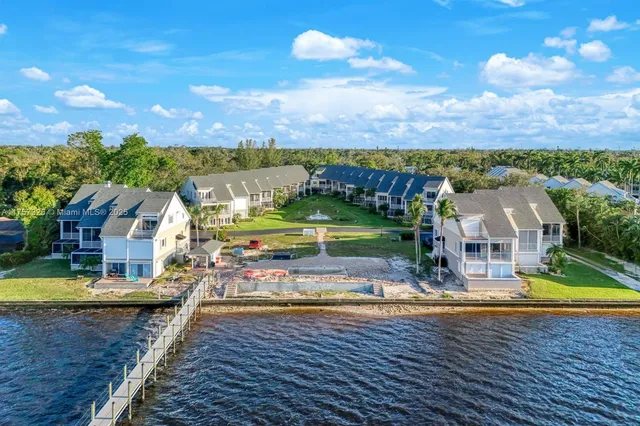 an aerial view of a house with swimming pool garden and patio