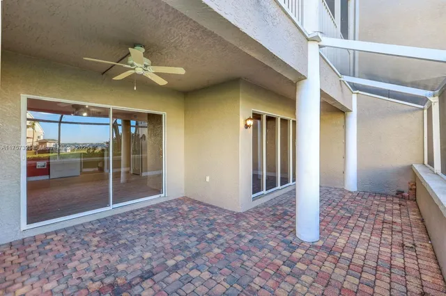 a view of a porch with furniture and floor to ceiling window