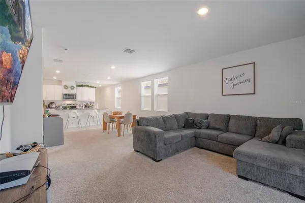 a living room with furniture and a dining table