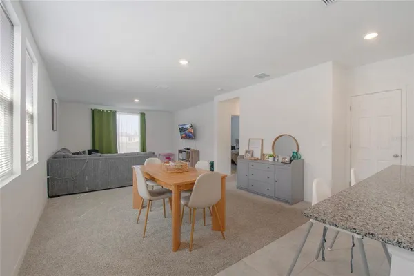 a bedroom with a bed and a flat tv screen on the dresser
