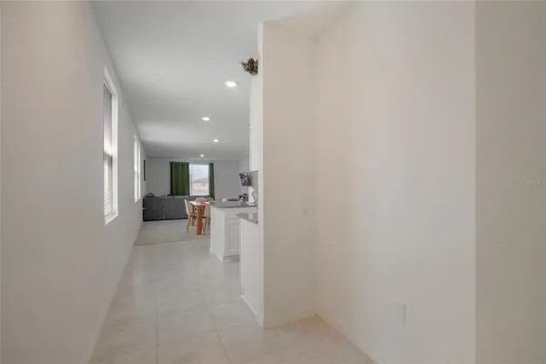 a view of a hallway with a table and chairs