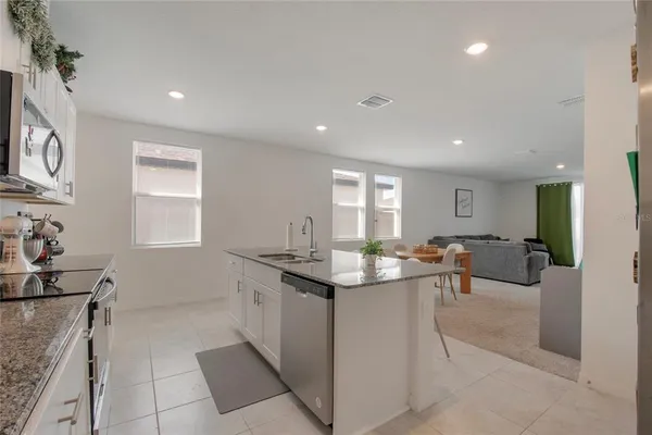 a kitchen with granite countertop a sink and cabinets