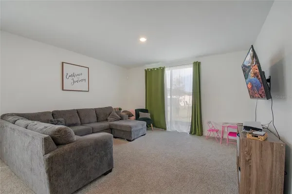 a living room with furniture and kitchen view