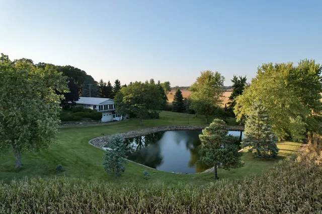 a front view of a house with a yard table and chairs