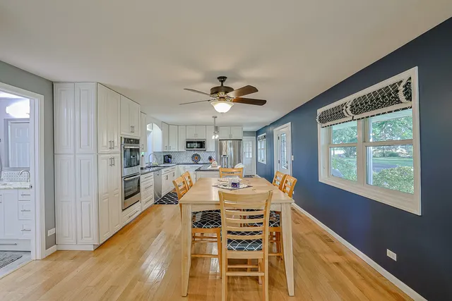 a living room with furniture ceiling fan and a window