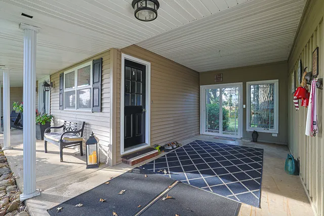a front view of a house with a garden and trees