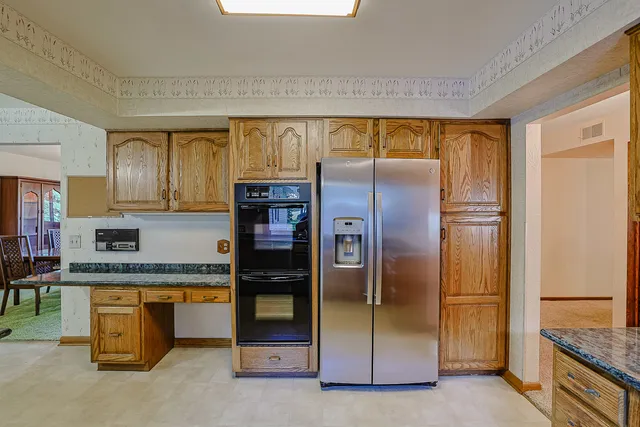 a view of kitchen with cabinets and window