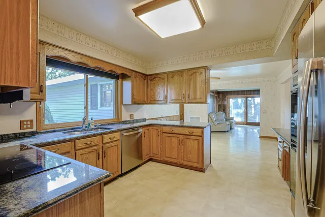 an empty room with a window and a ceiling fan