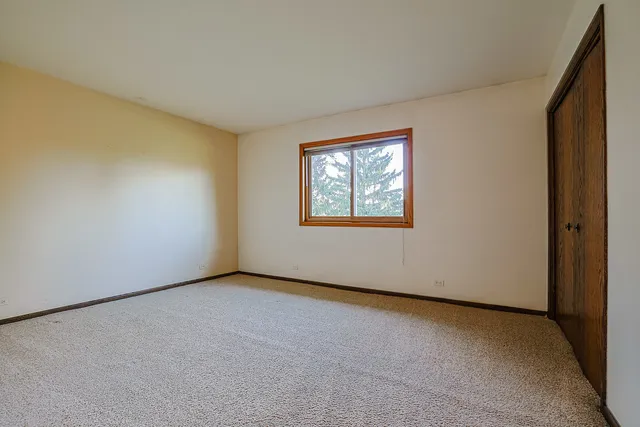 a dining room with furniture a chandelier and window