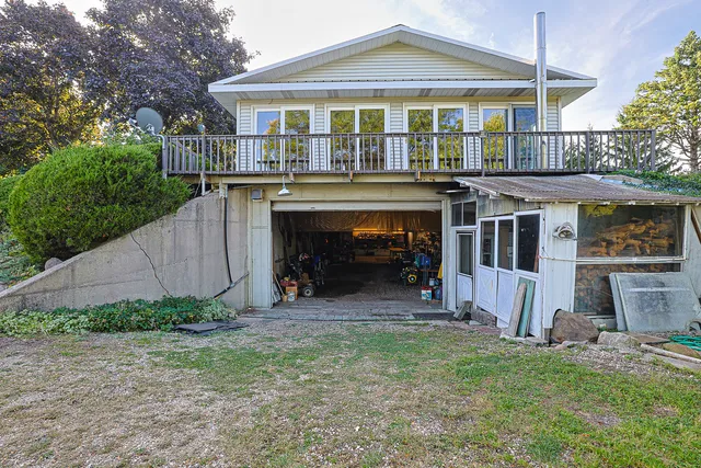 a view of a lake with a yard and large trees