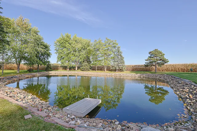 a view of a house with a yard and tree s
