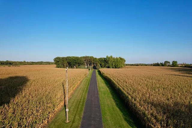 an aerial view of beach and residential houses with outdoor space