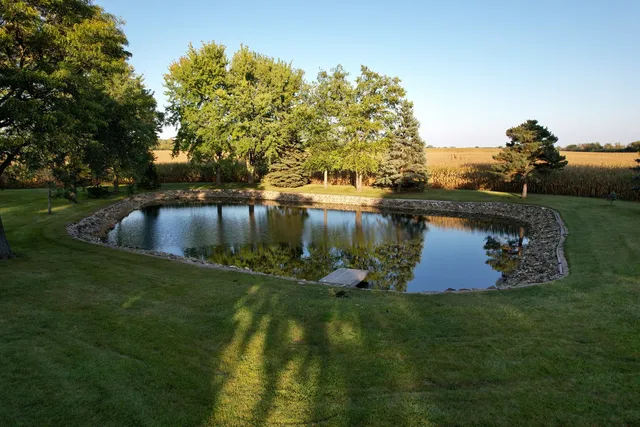 a view of a lake with a yard and mountain view