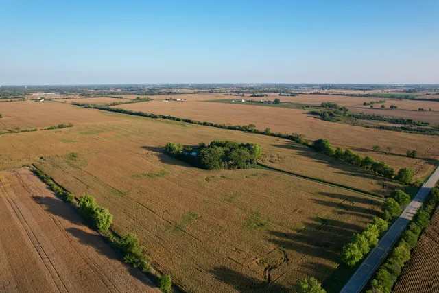 a view of a water pond with green yard