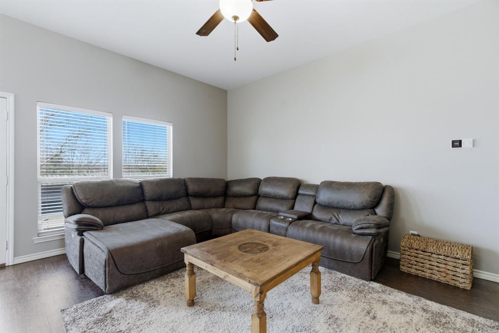 711 Hadley Lane Valley View, TX 76272 - Photo 8 of 40 Living room featuring ceiling fan and wood finished floors