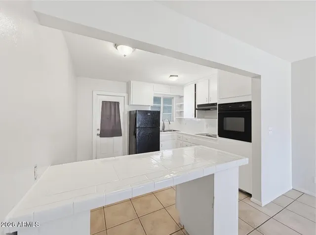 a kitchen with stainless steel appliances a refrigerator sink and microwave