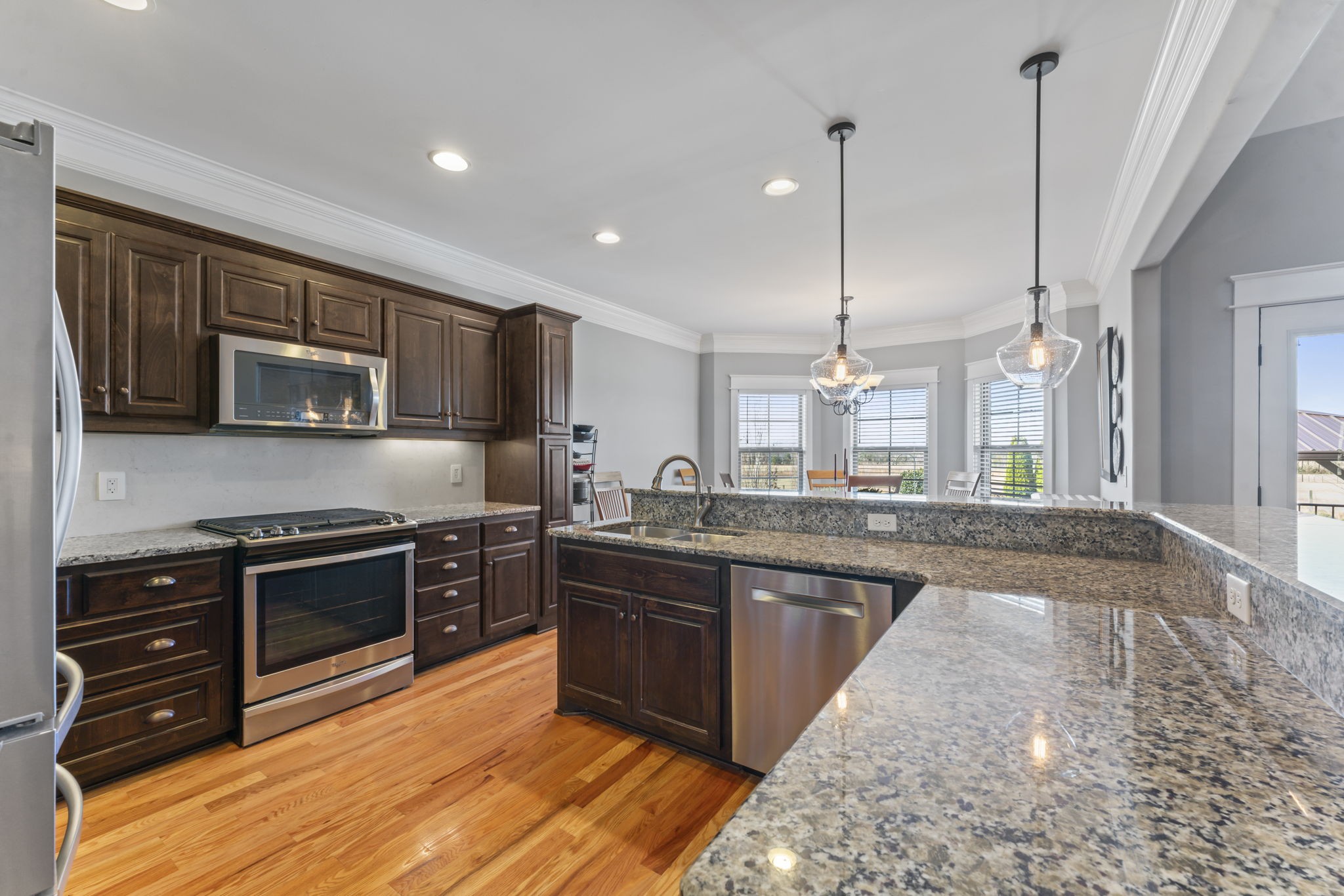203 County Line Road Bell Buckle, TN 37020 - Photo 11 of 31 a kitchen with stainless steel appliances granite countertop wooden cabinets a sink dishwasher a stove and a refrigerator with wooden floor