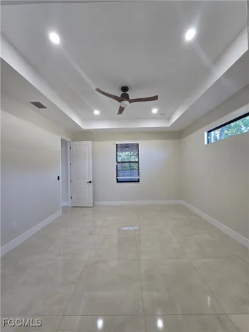 an empty room with a ceiling fan