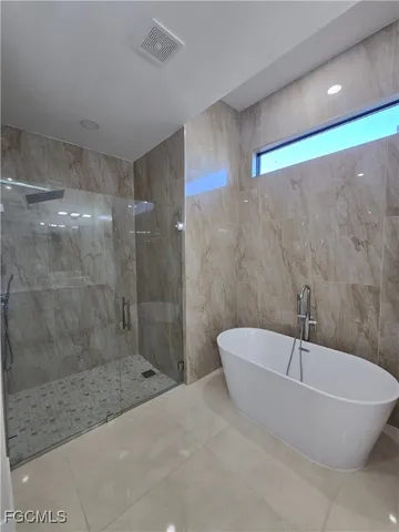 a bathroom with a bathtub and a shower