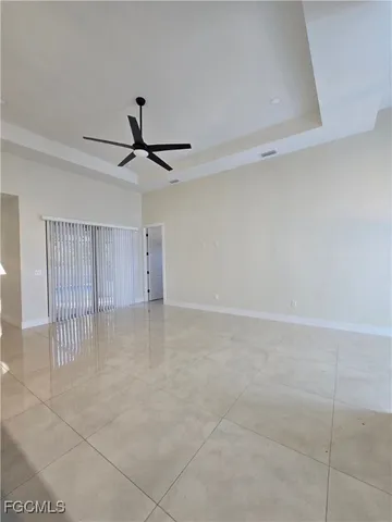 a view of a livingroom with a ceiling fan and window