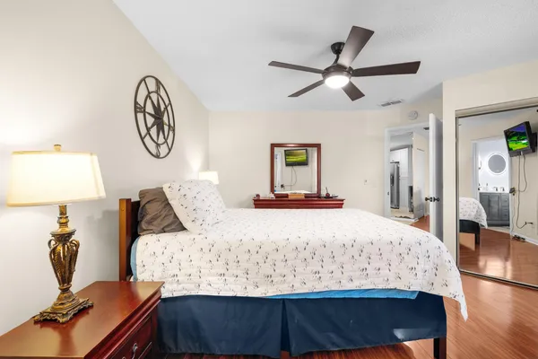 a bedroom with a bed and wooden floor