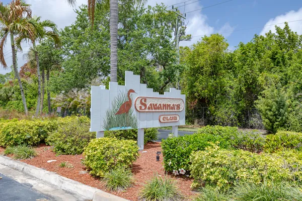 a sign broad in front of flowers