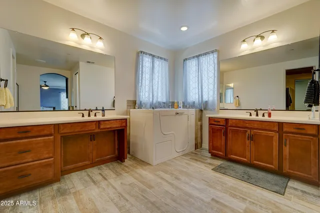 a view with cabinets wooden floor and a sink