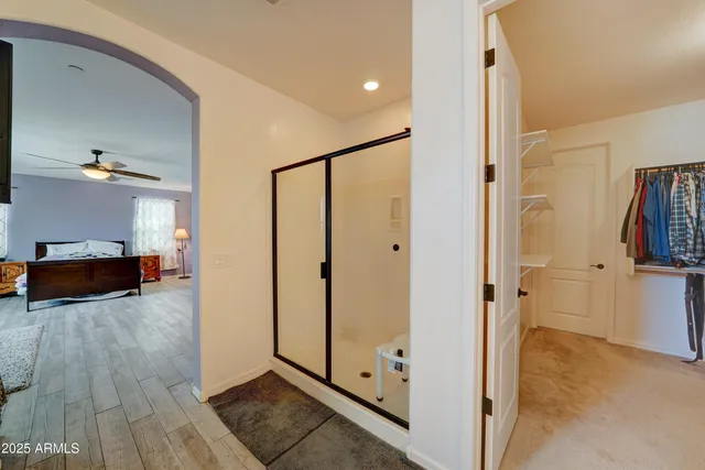 a view of a hallway with wooden floor and closet