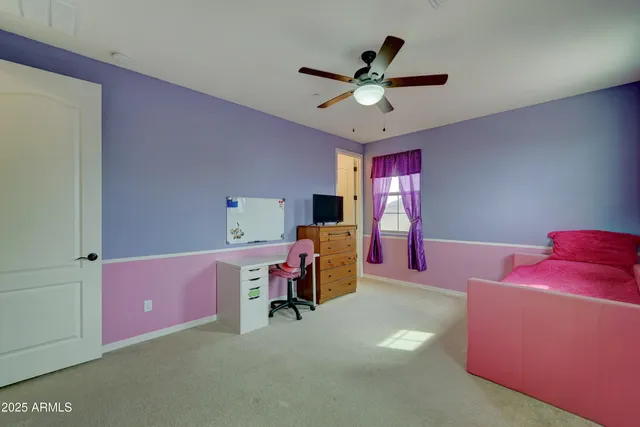 a view of a livingroom with furniture and a ceiling fan