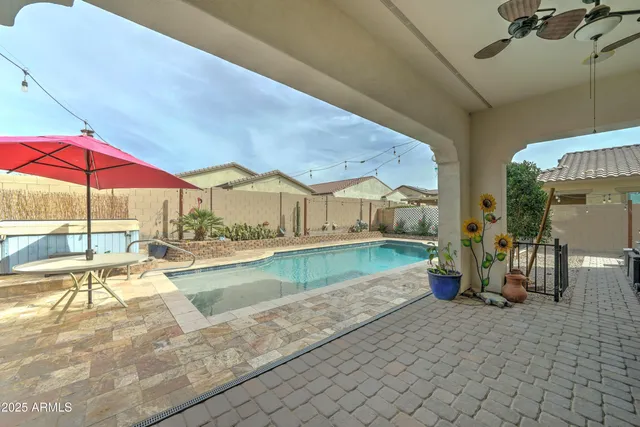a view of a patio with swimming pool table and chairs