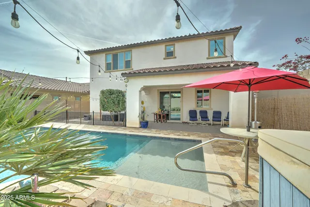 a view of a house with swimming pool and sitting area