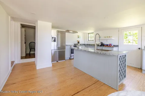 a kitchen with stainless steel appliances granite countertop a refrigerator and a stove top oven