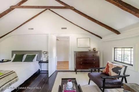 a bedroom with furniture and a fireplace