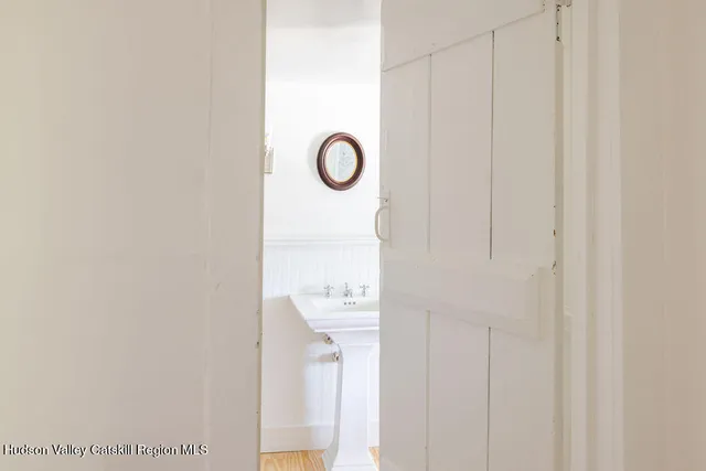 a picture of a bathroom with a sink and mirror