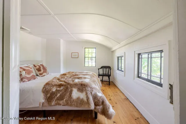 a bedroom with furniture and a window