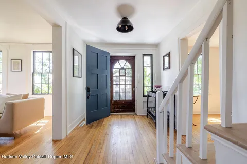 a view of an entryway with wooden floor and windows
